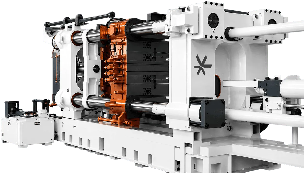 Giga-Thixomolding press: a large white molding machine with an orange mold clamped in its center